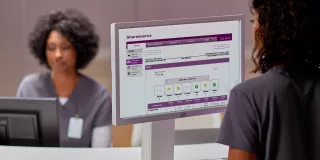 Nurse station and nurse is looking at a computer screen