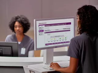 Nurse station and nurse is looking at a computer screen
